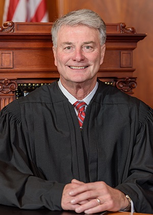Official portrait of Deputy Chief Justice Robert B. Conley.